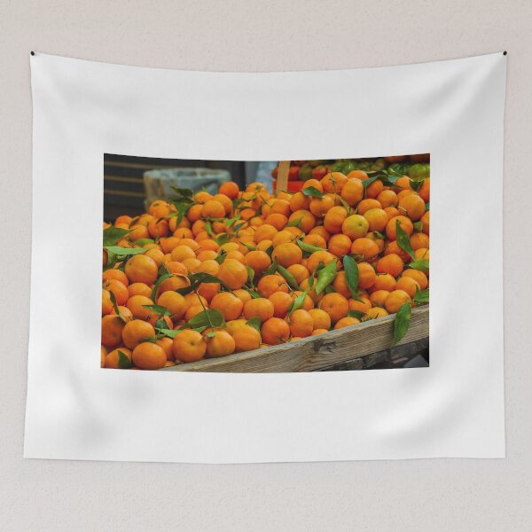 Item preview, Fresh Oranges Piled in a Wooden Crate at Market With Bright Green Leaves designed and sold by Nmallia.