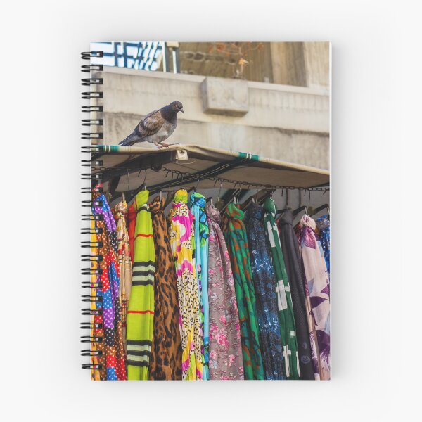 Item preview, Pigeon Perches On Market Stall Roof Above Vibrant Colorful Scarves And Fabrics designed and sold by Nmallia.