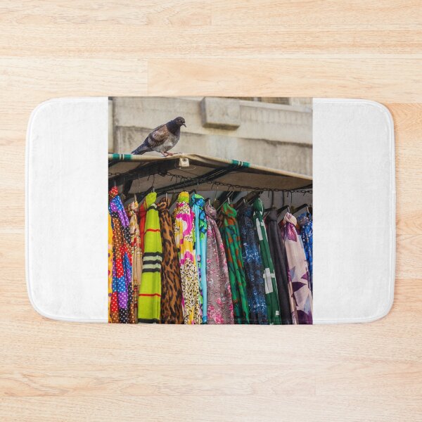 Item preview, Pigeon Perches On Market Stall Roof Above Vibrant Colorful Scarves And Fabrics designed and sold by Nmallia.