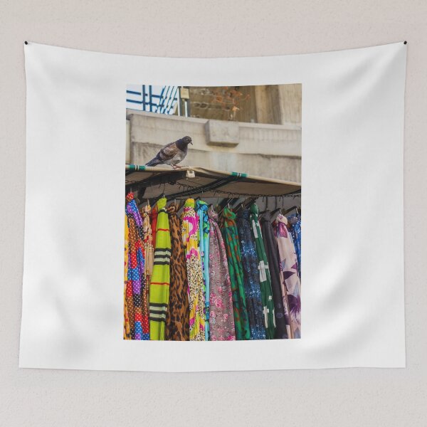 Item preview, Pigeon Perches On Market Stall Roof Above Vibrant Colorful Scarves And Fabrics designed and sold by Nmallia.
