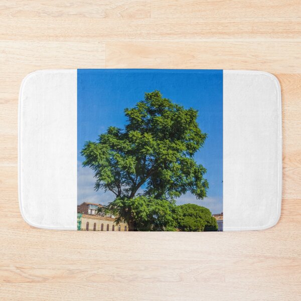 Item preview, Vibrant Green Tree Silhouette Against Clear Blue Sky Over Urban Park Scene During Sunny Day designed and sold by Nmallia.
