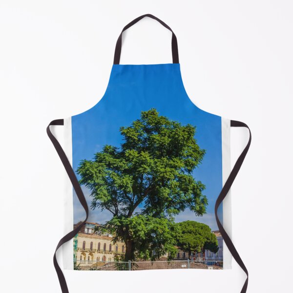 Item preview, Vibrant Green Tree Silhouette Against Clear Blue Sky Over Urban Park Scene During Sunny Day designed and sold by Nmallia.