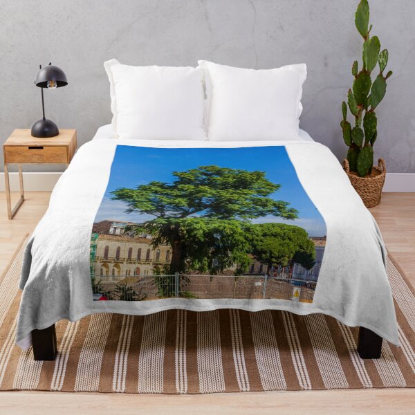 Item preview, Vibrant Green Tree Silhouette Against Clear Blue Sky Over Urban Park Scene During Sunny Day designed and sold by Nmallia.
