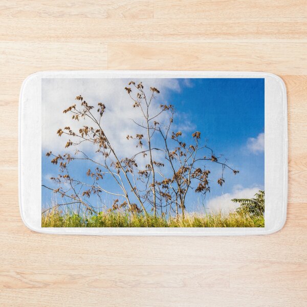 Item preview, Bare Trees Silhouetted Against Bright Blue Sky With Dry Branches and Grassy Foreground designed and sold by Nmallia.