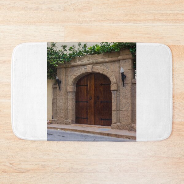 Item preview, Ancient Stone Archway With Wooden Doors And Green Vines Above A Street designed and sold by Nmallia.