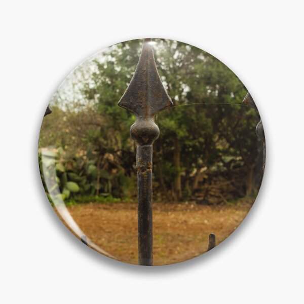 Item preview, Rusty Iron Fence Spikes In Front Of A Garden Yard With Greenery Background designed and sold by Nmallia.