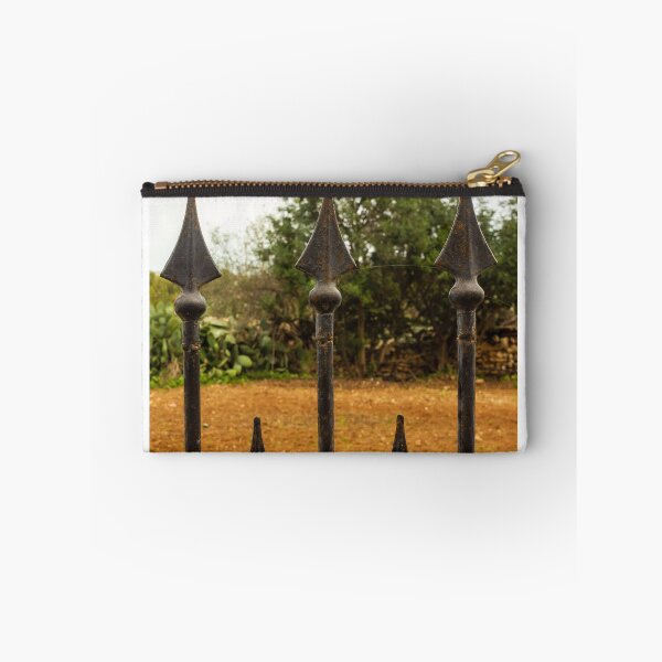 Item preview, Rusty Iron Fence Spikes In Front Of A Garden Yard With Greenery Background designed and sold by Nmallia.