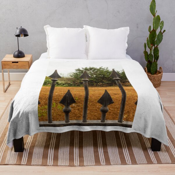 Item preview, Rusty Iron Fence Spikes In Front Of A Garden Yard With Greenery Background designed and sold by Nmallia.