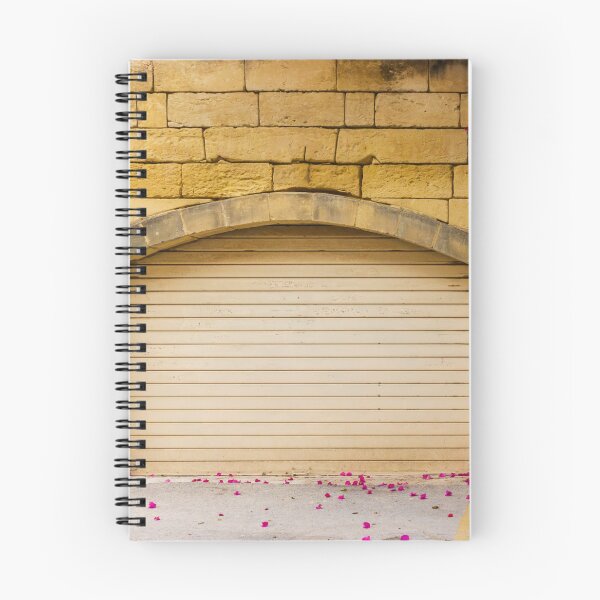 Item preview, Warm Yellow Stone Wall Archway With Closed Garage Door, Bougainvillea Blooms And Pink Petals designed and sold by Nmallia.