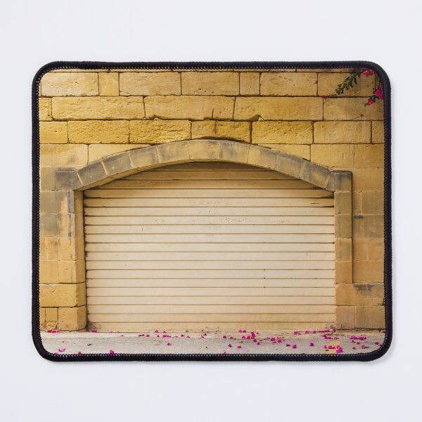 Item preview, Warm Yellow Stone Wall Archway With Closed Garage Door, Bougainvillea Blooms And Pink Petals designed and sold by Nmallia.