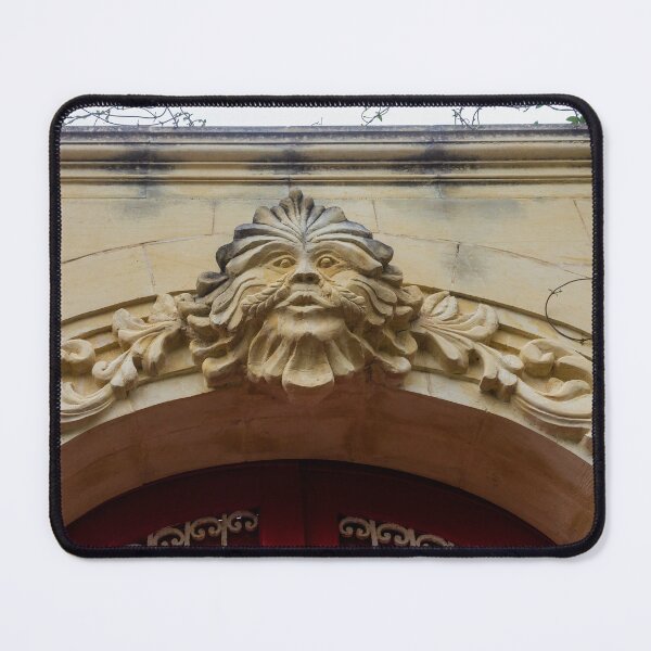 Item preview, Ornate Stone Archway With Carved Face Sculpture And Vine Details Above Red Door designed and sold by Nmallia.