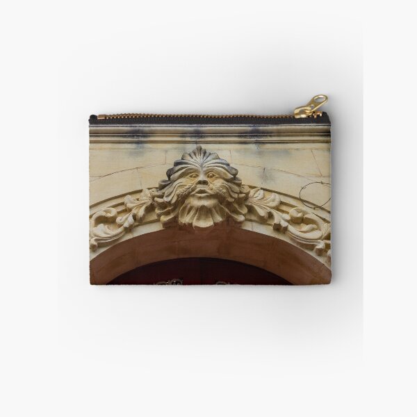 Item preview, Ornate Stone Archway With Carved Face Sculpture And Vine Details Above Red Door designed and sold by Nmallia.