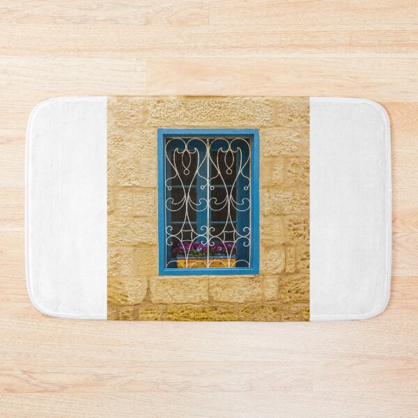 Item preview, Bright Blue Window With Ornate White Grilles And Colorful Flower Box On Yellow Stone Wall designed and sold by Nmallia.