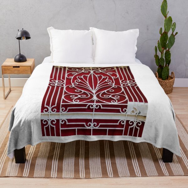 Item preview, Ornate White Iron Gate With Curved Scrollwork Against Deep Red Background Architectural Facade Decor Art designed and sold by Nmallia.