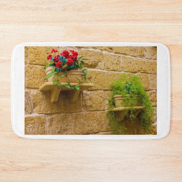Item preview, Rustic Wall Planters With Red Geraniums And Green Trailing Plants On Stone Wall designed and sold by Nmallia.