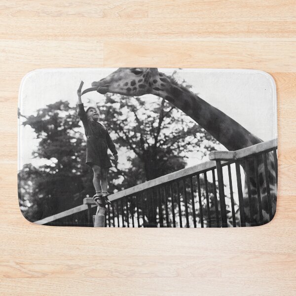 Item preview, Vintage funny A Father Helping His Son Feed A Giraffe At London Zoo black and white photographic art print designed and sold by Astrid Arkhangelsky.