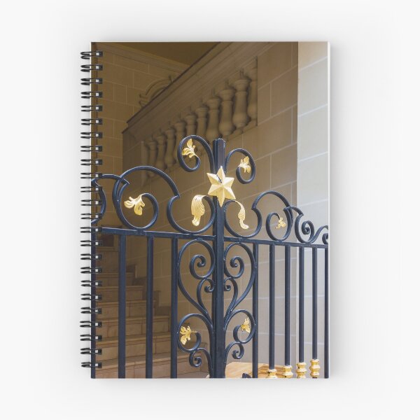 Item preview, Elegant Black Wrought Iron Gate With Gold Finials Set Against Beige Stone Wall designed and sold by Nmallia.