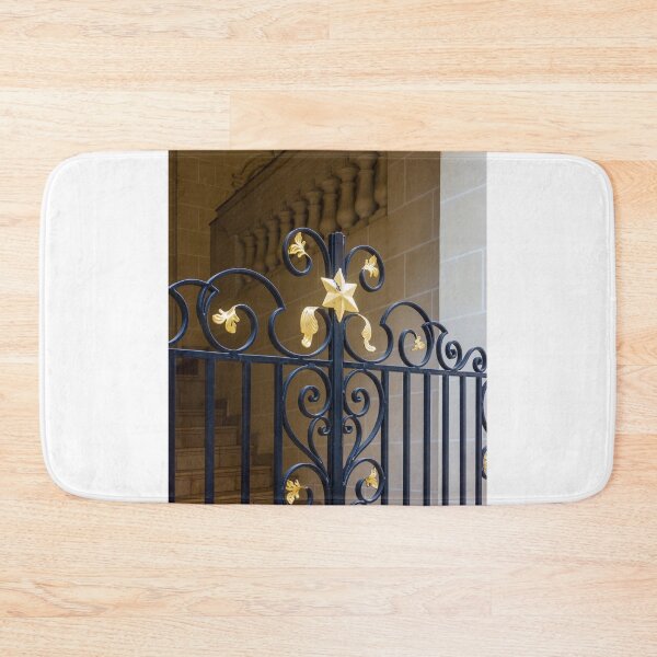 Item preview, Elegant Black Wrought Iron Gate With Gold Finials Set Against Beige Stone Wall designed and sold by Nmallia.