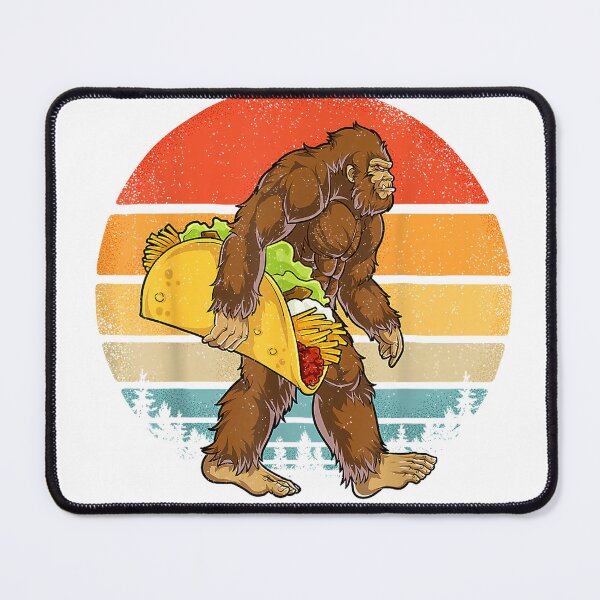 Item preview, Bigfoot Carrying Taco Funny Cinco de Mayo Boys Men Sasquatch T-Shirt designed and sold by Julian Segers.