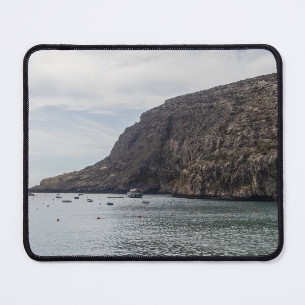 Item preview, Boats Anchored in a Quiet Rocky Bay Beneath a Dramatic Cliffside Under Overcast Sky designed and sold by Nmallia.