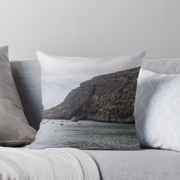 Item preview, Boats Anchored in a Quiet Rocky Bay Beneath a Dramatic Cliffside Under Overcast Sky designed and sold by Nmallia.