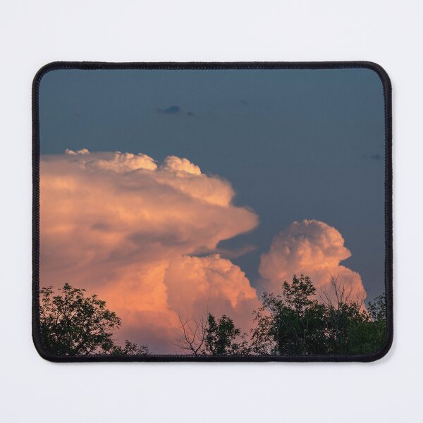 Item preview, Salmon pink cumulonimbus clouds at sunset with trees in foreground designed and sold by lisavonbiela.
