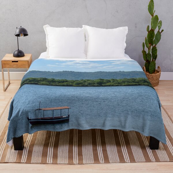 Item preview, Serene Coastal River Landscape With Traditional Wooden Boat and Lush Green Hills designed and sold by ThaCriações.