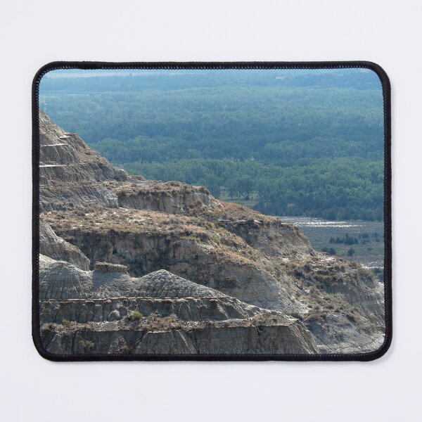 Item preview, Badland formation at Theodore Roosevelt National Park with trees in the distance designed and sold by lisavonbiela.