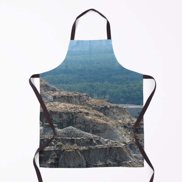 Item preview, Badland formation at Theodore Roosevelt National Park with trees in the distance designed and sold by lisavonbiela.
