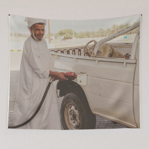 Item preview, Man in Oman filling up car at gas station designed and sold by Photopat.