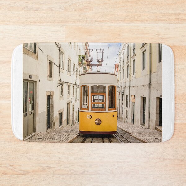 Item preview, Yellow Vintage Tram Ascending Steep Cobblestone Street In Lisbon designed and sold by Laughline.