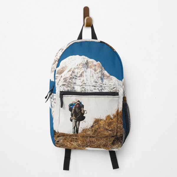 Item preview, Porter Carrying Heavy Backpack Ahead Of Snow Covered Mountain Peak designed and sold by Matricko.