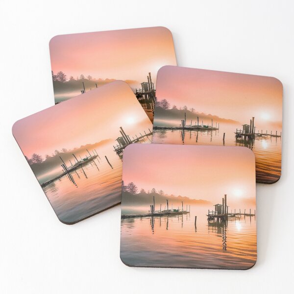 Item preview, Tranquil sunrise over a wooden pier and hut on calm water designed and sold by homydesign.