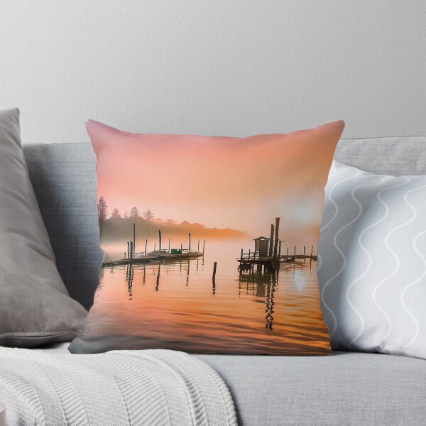 Item preview, Tranquil sunrise over a wooden pier and hut on calm water designed and sold by homydesign.