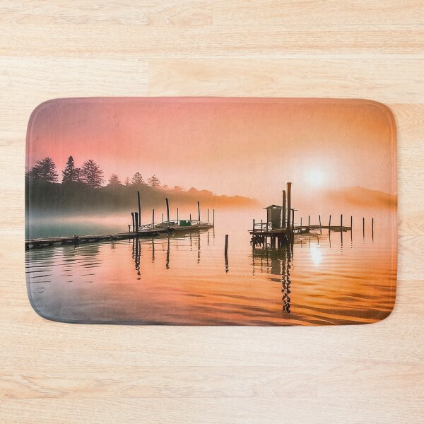 Item preview, Un amanecer tranquilo sobre un muelle de madera y una cabaña en aguas tranquilas. designed and sold by homydesign.