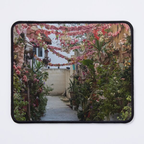 Item preview, Flower-Decked Narrow Alleyway With Hanging Pink Garlands And Lush Potted Plants designed and sold by Nmallia.