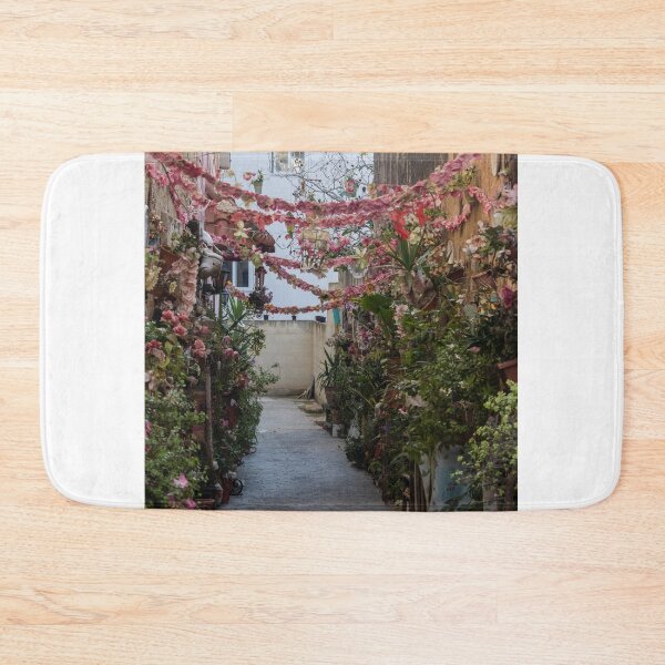 Item preview, Flower-Decked Narrow Alleyway With Hanging Pink Garlands And Lush Potted Plants designed and sold by Nmallia.