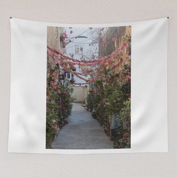 Item preview, Flower-Decked Narrow Alleyway With Hanging Pink Garlands And Lush Potted Plants designed and sold by Nmallia.