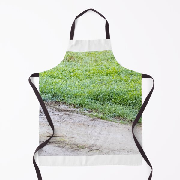 Item preview, Dewy Grass Beside Muddy Dirt Road With Tire Tracks and Green Field in Morning Light designed and sold by Nmallia.