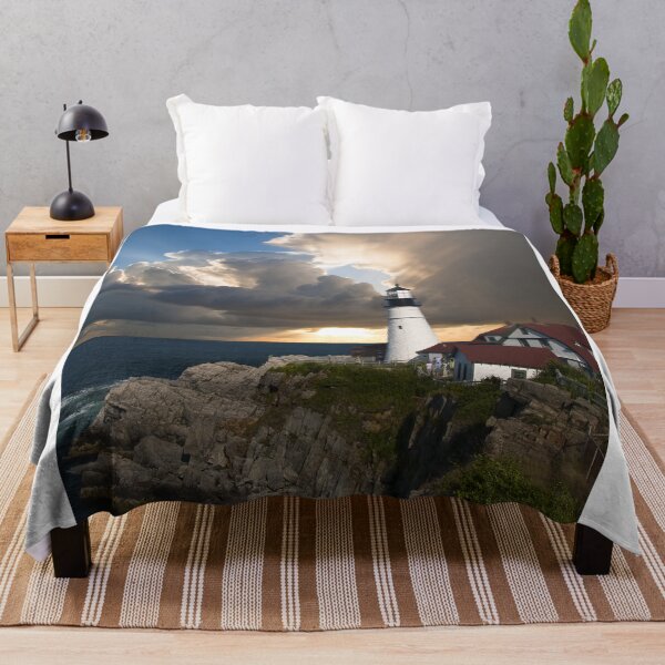 Item preview, Historic White Lighthouse On Rocky Coast Under Dramatic Sunset Sky designed and sold by simonwarz.