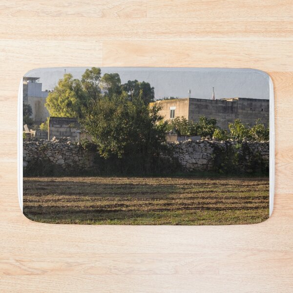 Item preview, Sunlit Rural Field With Stone Wall and Tree Near Farmhouse in Mediterranean Countryside designed and sold by Nmallia.