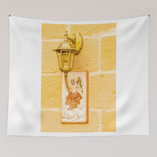Item preview, Vintage Wall Lantern Above Ceramic Saint Plaque On Textured Yellow Stone Exterior Wall designed and sold by Nmallia.
