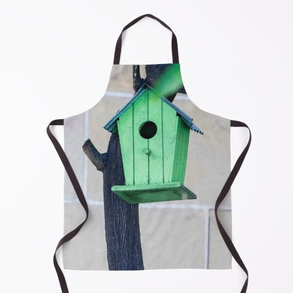 Item preview, Green Wooden Birdhouse Mounted On Tree Trunk In Backyard Garden Close-Up designed and sold by Nmallia.