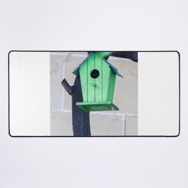 Item preview, Green Wooden Birdhouse Mounted On Tree Trunk In Backyard Garden Close-Up designed and sold by Nmallia.