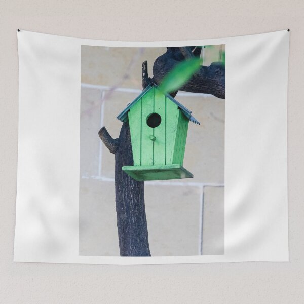 Item preview, Green Wooden Birdhouse Mounted On Tree Trunk In Backyard Garden Close-Up designed and sold by Nmallia.