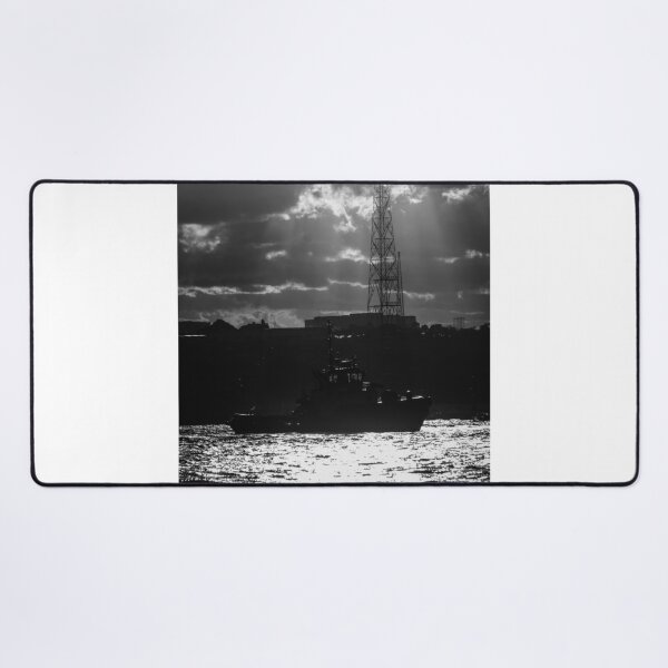 Item preview, Silhouette Tugboat at Sunset With Industrial Tower and Dramatic Sun Rays Over Water designed and sold by Nmallia.