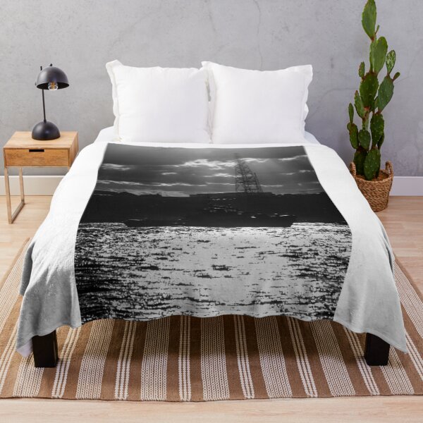 Item preview, Silhouette Tugboat at Sunset With Industrial Tower and Dramatic Sun Rays Over Water designed and sold by Nmallia.