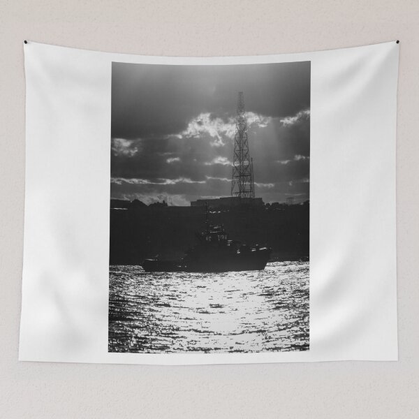 Item preview, Silhouette Tugboat at Sunset With Industrial Tower and Dramatic Sun Rays Over Water designed and sold by Nmallia.