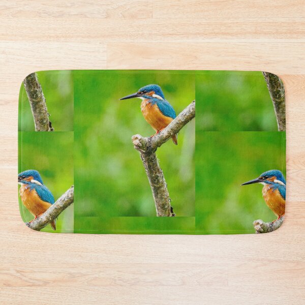 Item preview, Common Kingfisher Perched On Wooden Post Against Green Background designed and sold by Foxieri.