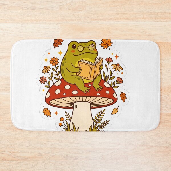 Item preview, Cute Cottagecore Frog Reading a Book on a Mushroom - Cozy Bookish Aesthetic Sticker designed and sold by scarben.